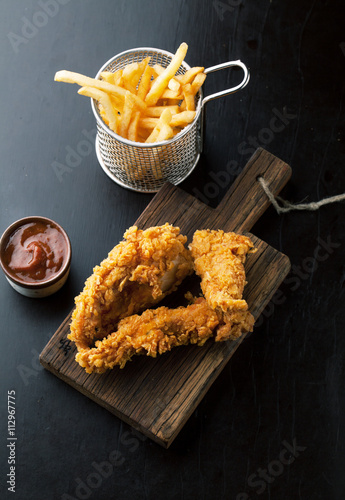 Fried chicken legs with fried potatoes photo