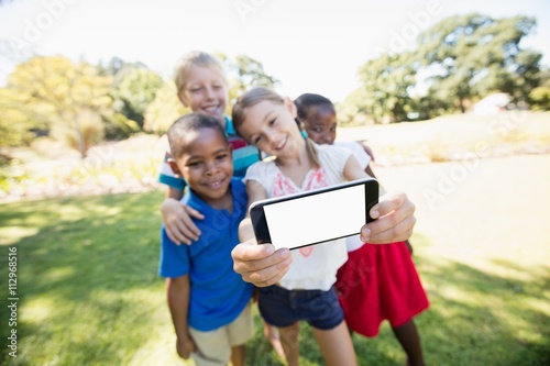Kids are taking a selfie during a sunny day