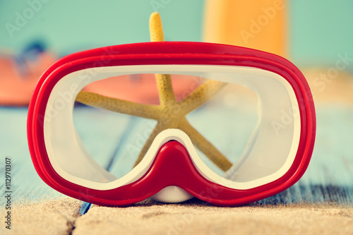 sand, dive mask and starfish photo