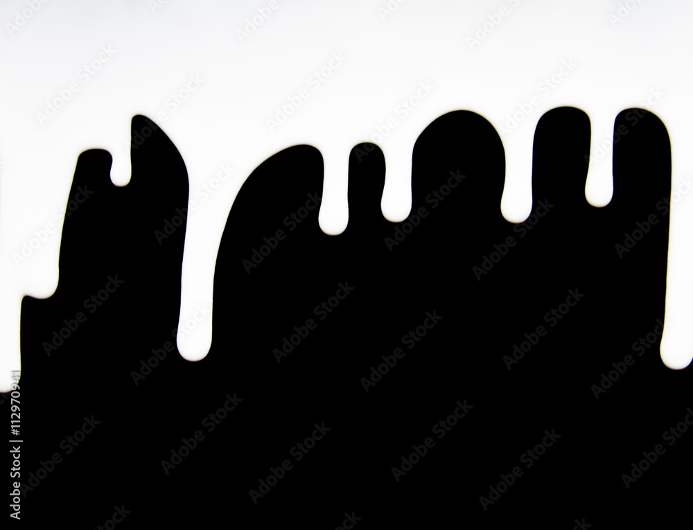 milk dripping isolated on black background milk dripping isolated on black background