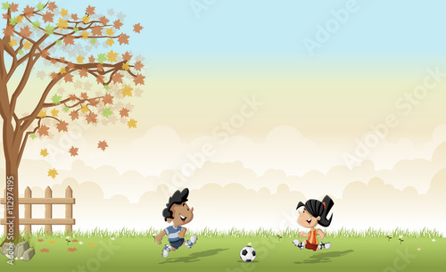 Green grass landscape with boy and girl playing football / soccer