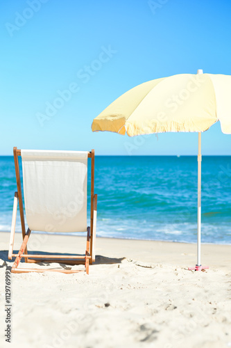 Fototapeta Naklejka Na Ścianę i Meble -  Chair and umbrella on stunning tropical beach background vacation 