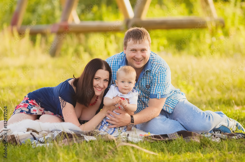 Happy family having fun outdoors in spring field. Summer photo.Blurred background. Happy family having fun outdoors in spring field. Summer photo.Blurred background.