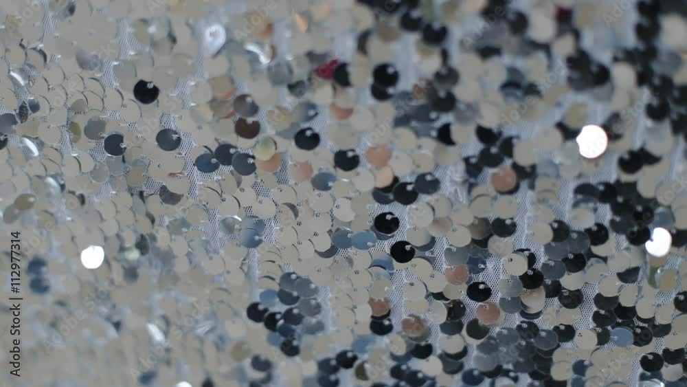 Close-up fabric texture, covered with reflective dots that give the image its glitter. Close-up fabric texture, covered with reflective dots that give the image its glitter.