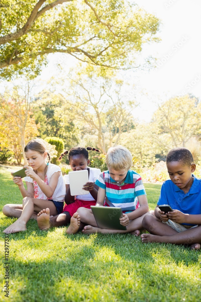 Kids using technology during a sunny day