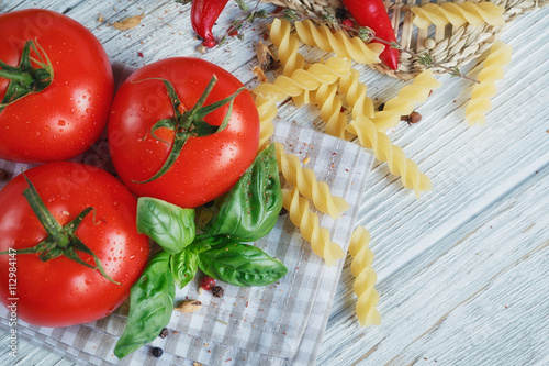 Italian food background, with tomatoes, basil, pasta, olive oil,