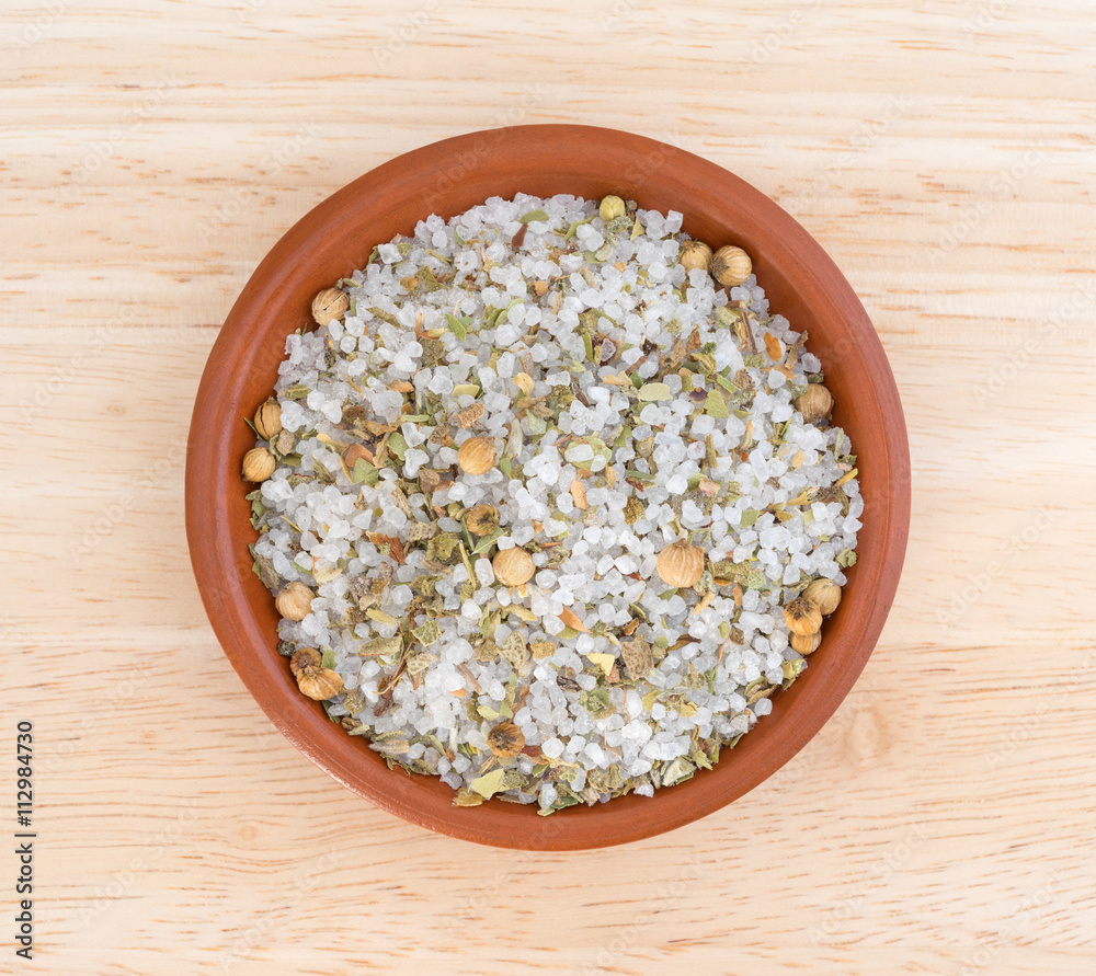 Simple Moroccan blend of spices in a bowl on a wood table top view Simple Moroccan blend of spices in a bowl on a wood table top view