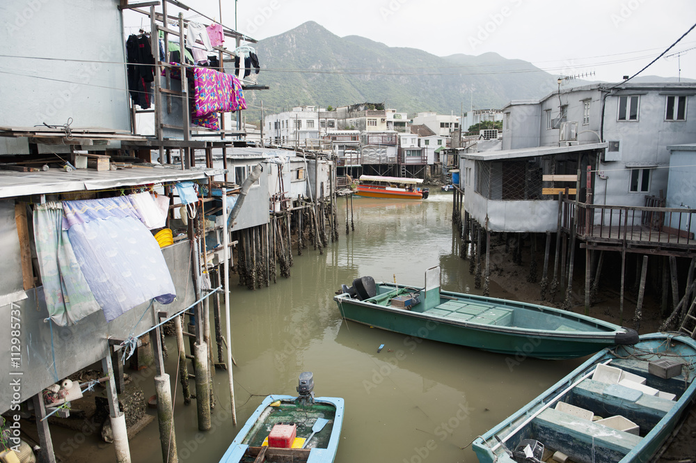 Boats and elevated houses in Chinese fishing village in Tai O