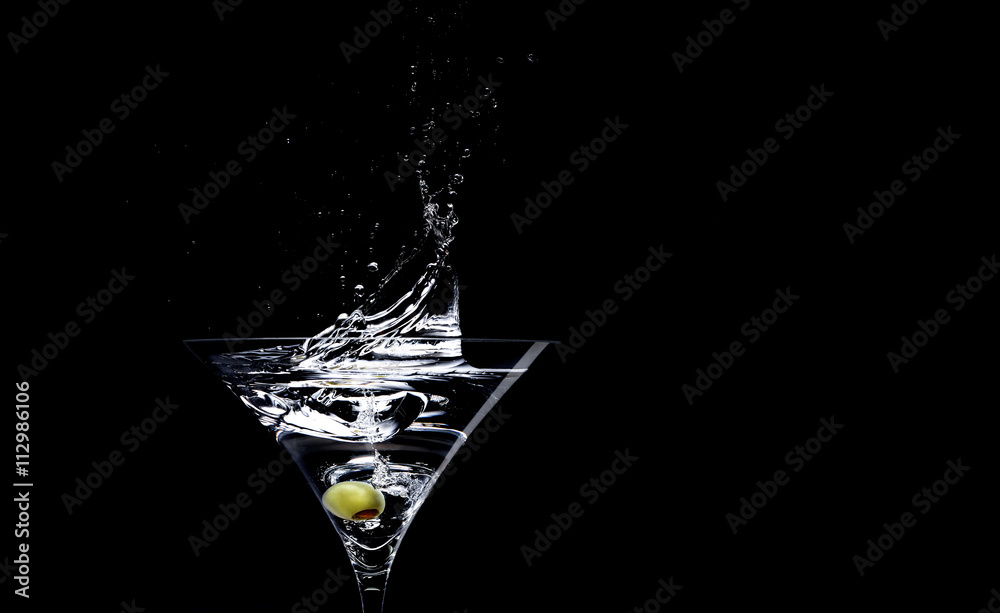 Martini with olive against black background Stock Photo | Adobe Stock
