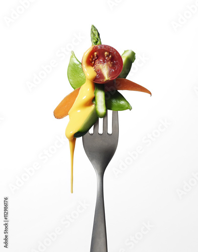 Fork with vegetables and melting cheese