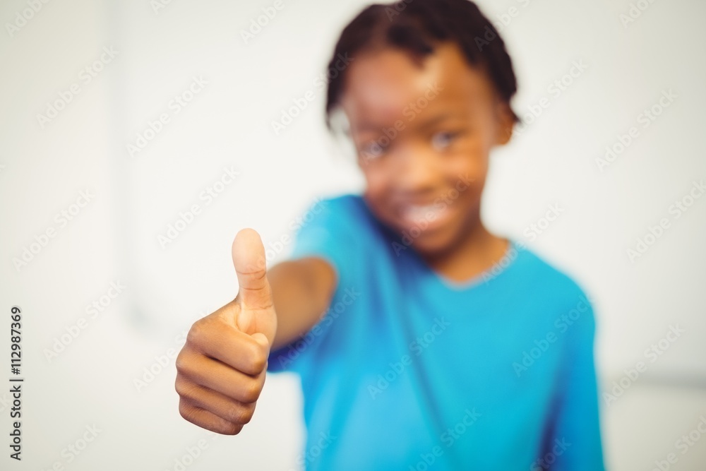 Portrait of smiling schoolboy showing thumbs Portrait of smiling schoolboy showing thumbs
