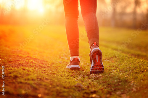 Woman and running shoes, exercising in nature.
