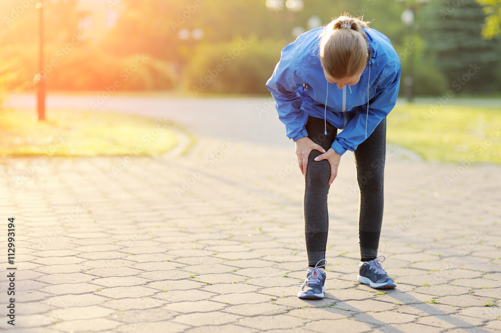 Fototapeta premium Injuries - sports running knee injury on woman.