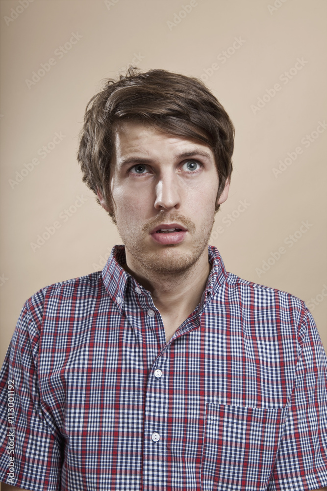 Portrait of a man looking confused, studio shot Portrait of a man looking confused, studio shot
