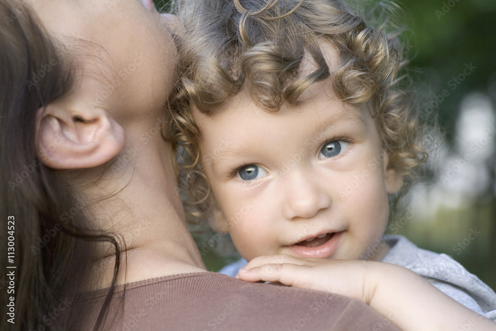 Portrait of a young boy being held by a young woman Portrait of a young boy being held by a young woman