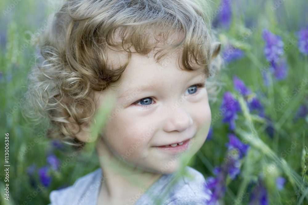 Portrait of a young boy looking away smiling Portrait of a young boy looking away smiling