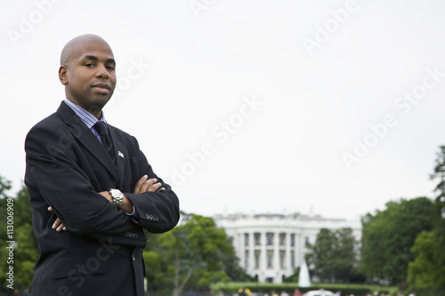 Portrait of a man standing in front of the White House, Washington DC, USA