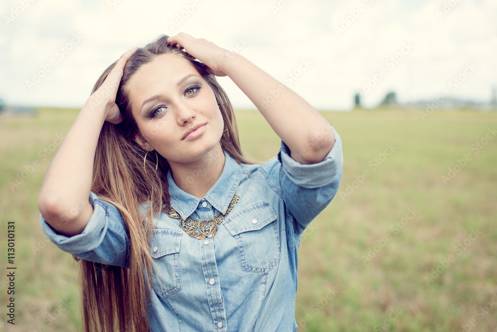 closeup portrait of beautiful brunette young woman having fun relaxing happy smiling and looking at camera on summer green field outdoors copy space background closeup portrait of beautiful brunette young woman having fun relaxing happy smiling and looking at camera on summer green field outdoors copy space background