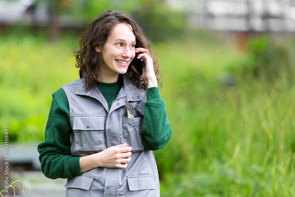 Young attractive woman working in a public garden using mobile Young attractive woman working in a public garden using mobile