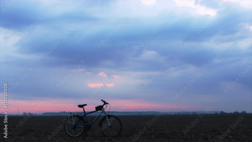 Sunrise over a field. Bike in the foreground. Sunrise over a field. Bike in the foreground.