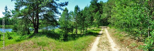  Forest road along the blue lake. Panoramic image. 