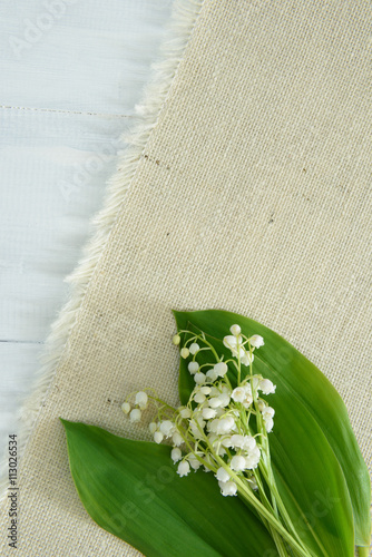 Lily of the valley on wooden background