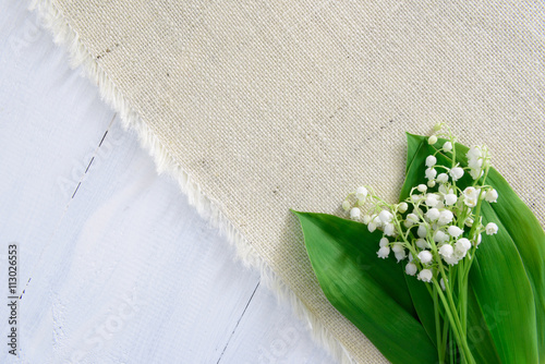 Lily of the valley on wooden background