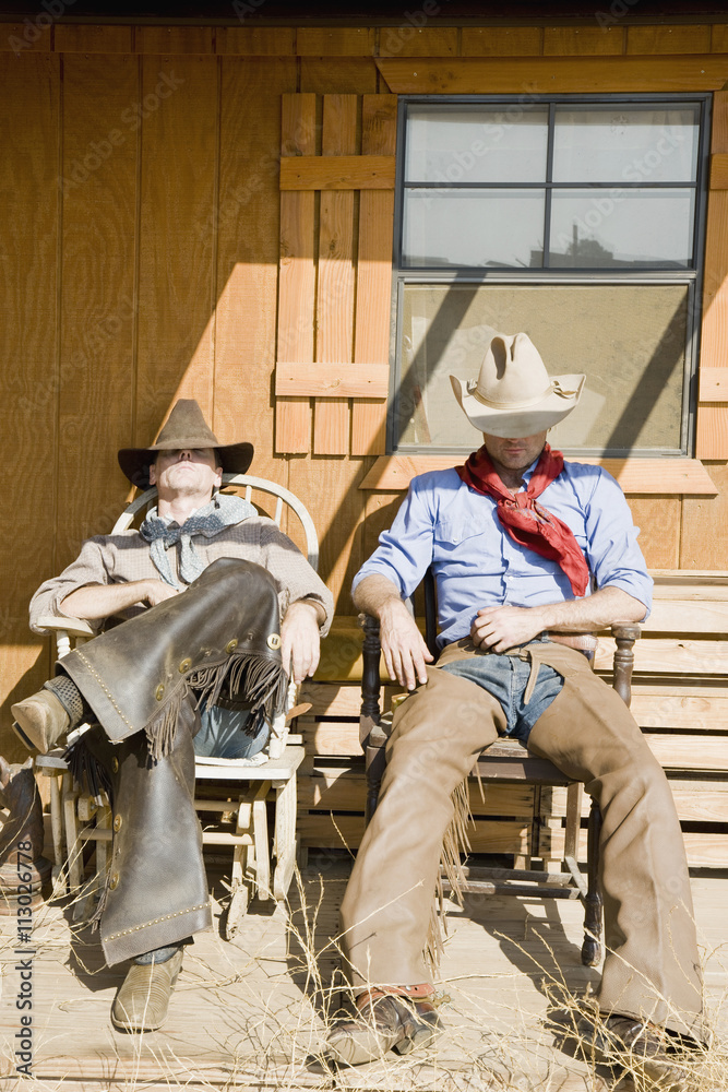 Two cowboys sleeping in chairs Two cowboys sleeping in chairs