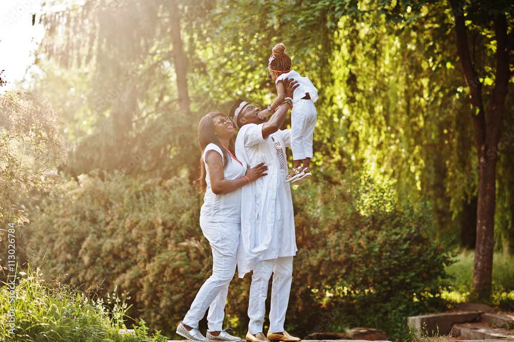 Fototapeta premium African american rich family having fun on sunset. Father throws