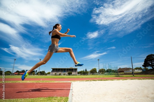 Female athlete performing a long jump