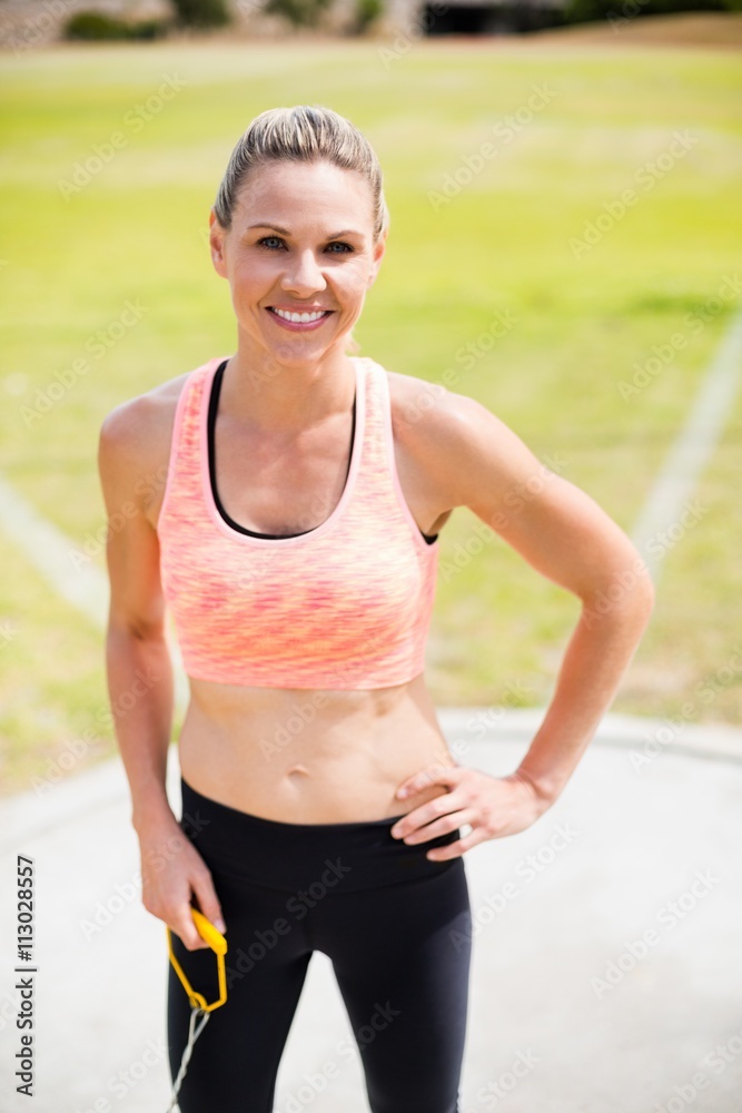 Portrait of female athlete standing with hands on hips Portrait of female athlete standing with hands on hips