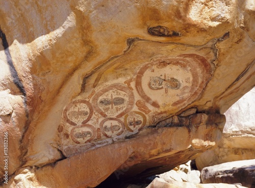 Group of Wandjana 'faces' on shaded underside of rock, near King Edward River, Kulumburu Road, Kimberley, Western Australia