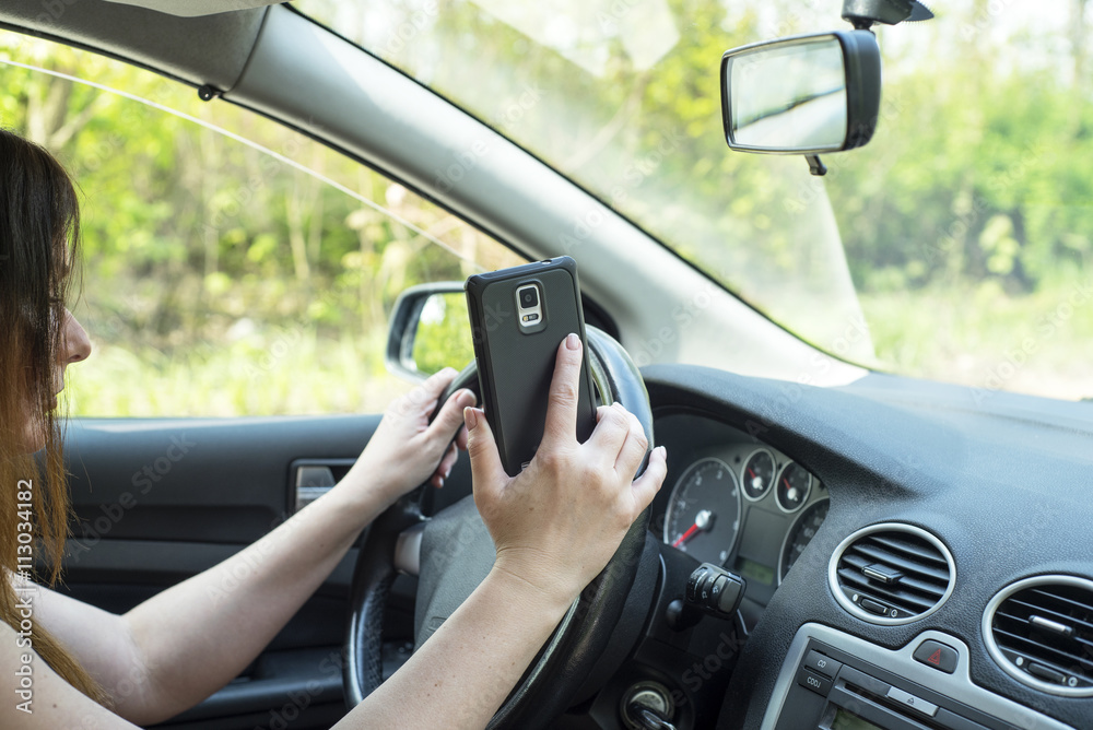 woman with a smartphone in the car woman with a smartphone in the car