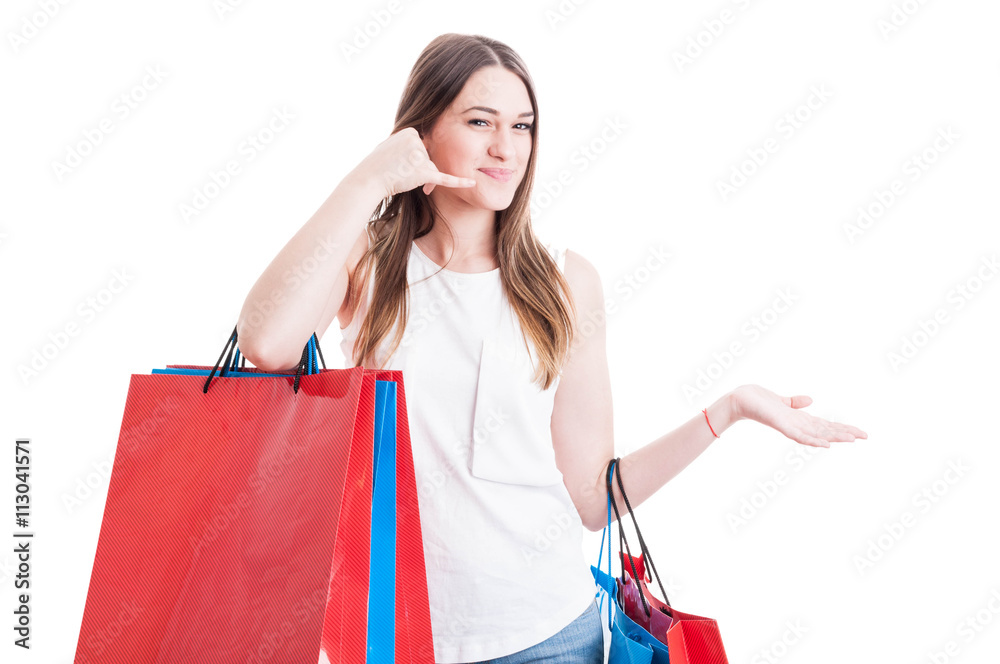 Positive girl on shopping making a call gesture with hand Positive girl on shopping making a call gesture with hand