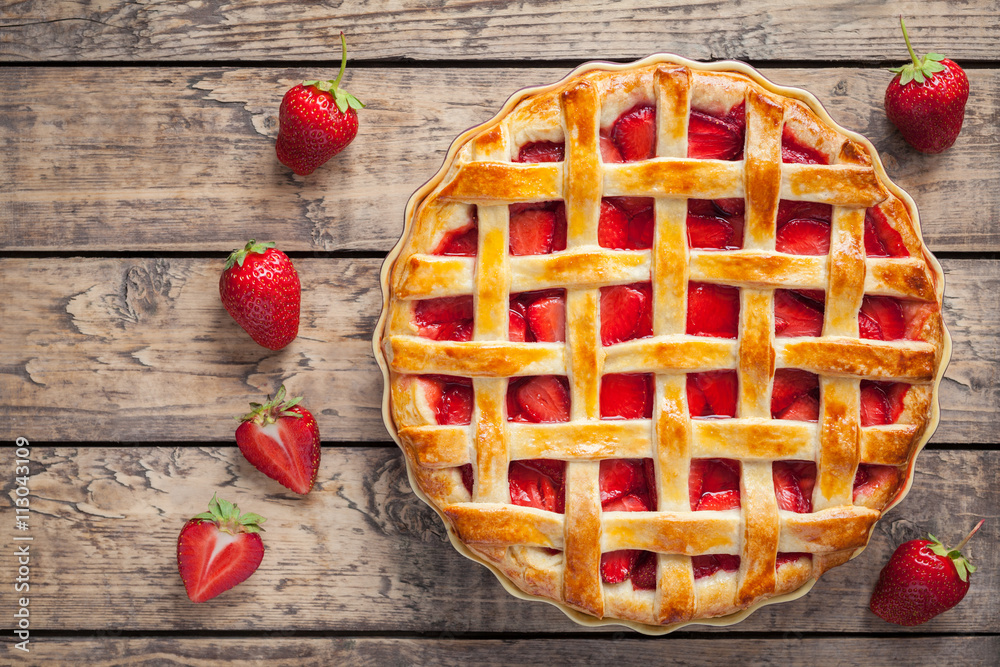 Homemade strawberry tart pie cake traditional sweet pastry food on rustic wooden table background Homemade strawberry tart pie cake traditional sweet pastry food on rustic wooden table background