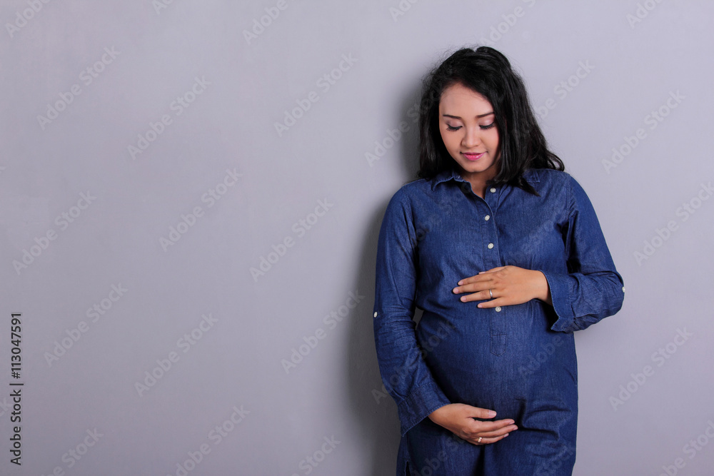 Caress of pregnant mom, with copyspace Caress of pregnant mom, with copyspace