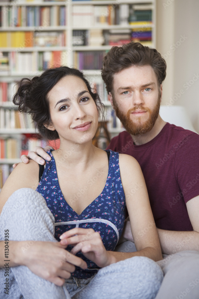 Portrait of young woman with man relaxing at home Portrait of young woman with man relaxing at home
