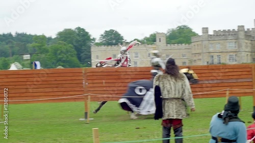 Slow motion view of a medieval joust with knights in armour and costume