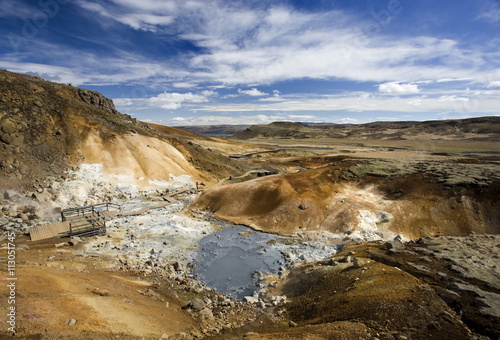 Dramatic volcanic landscape with mudpools in geothermal area on Reykjanes Peninsula, near Keflavik, Iceland photo