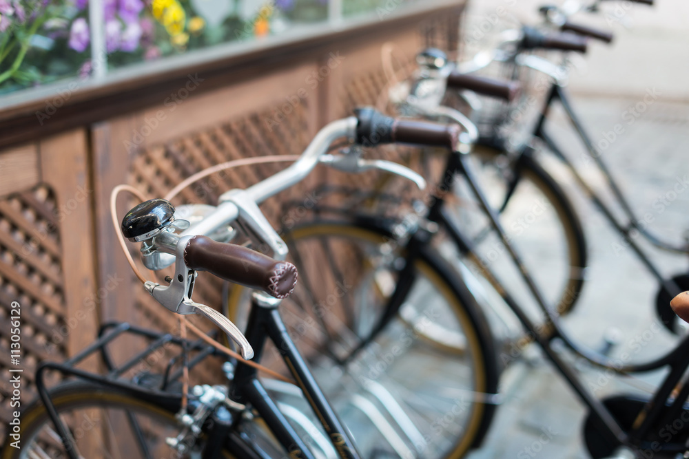 Fototapeta premium Black vintage bicycles in a bike stand