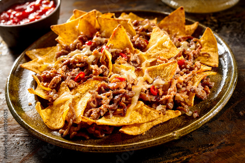 Plate full of nachos and ground beef