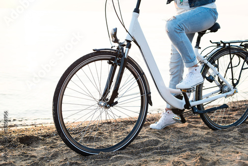 Young girl riding a bike at the seaside