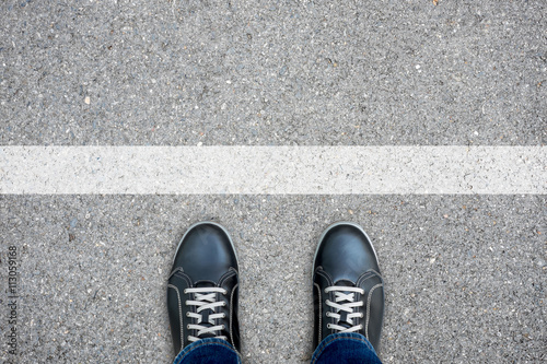Black casual shoes standing at the white line photo