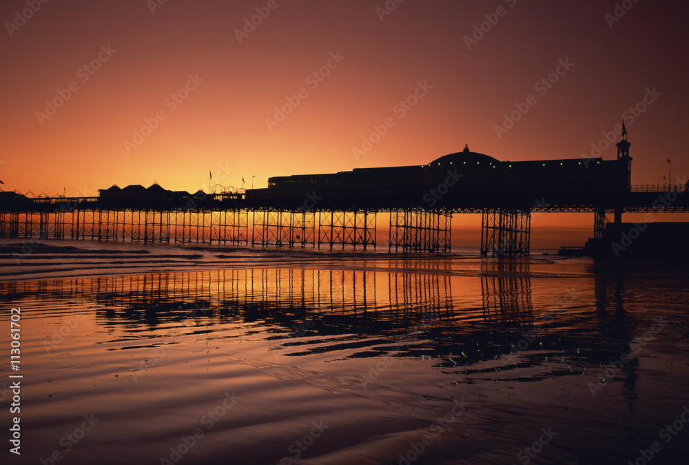 Reflections in the sea of the pier at Brighton at sunset, Sussex Reflections in the sea of the pier at Brighton at sunset, Sussex