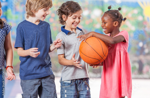 Mixed race classmates playing in schoolyard