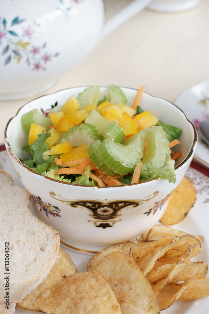 Celery and capiscum side salad served with potato chips and a sandwich Celery and capiscum side salad served with potato chips and a sandwich
