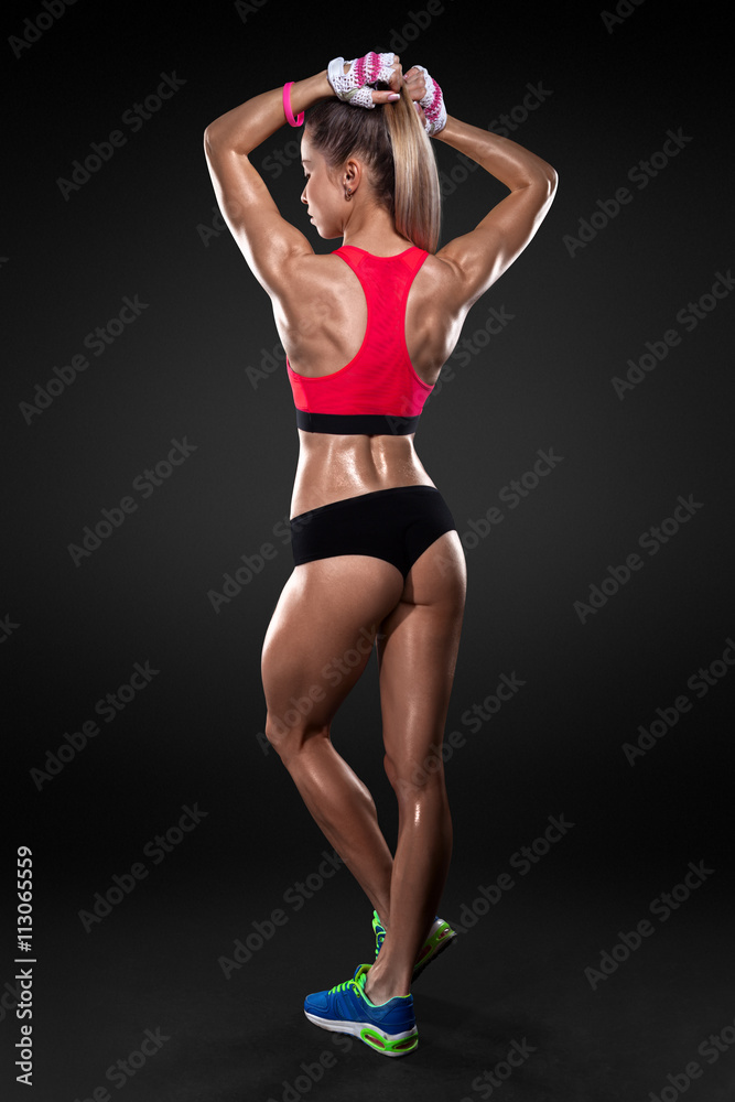 Athletic young woman showing muscles of the back