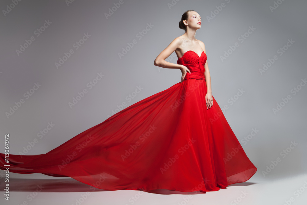 Model with flying skirt of red dress Model with flying skirt of red dress