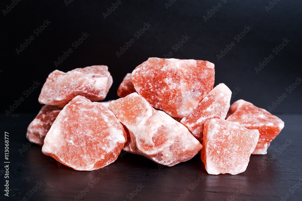 Himalayan pink crystal salt on dark background Himalayan pink crystal salt on dark background