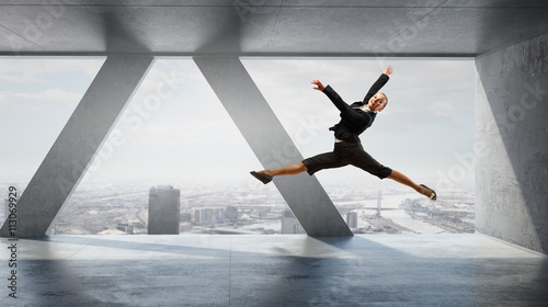 Dancing businesswoman in office